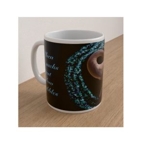 Angled black ceramic mug featuring turquoise bubbles, part of an elephant illustration and blue lettering.
