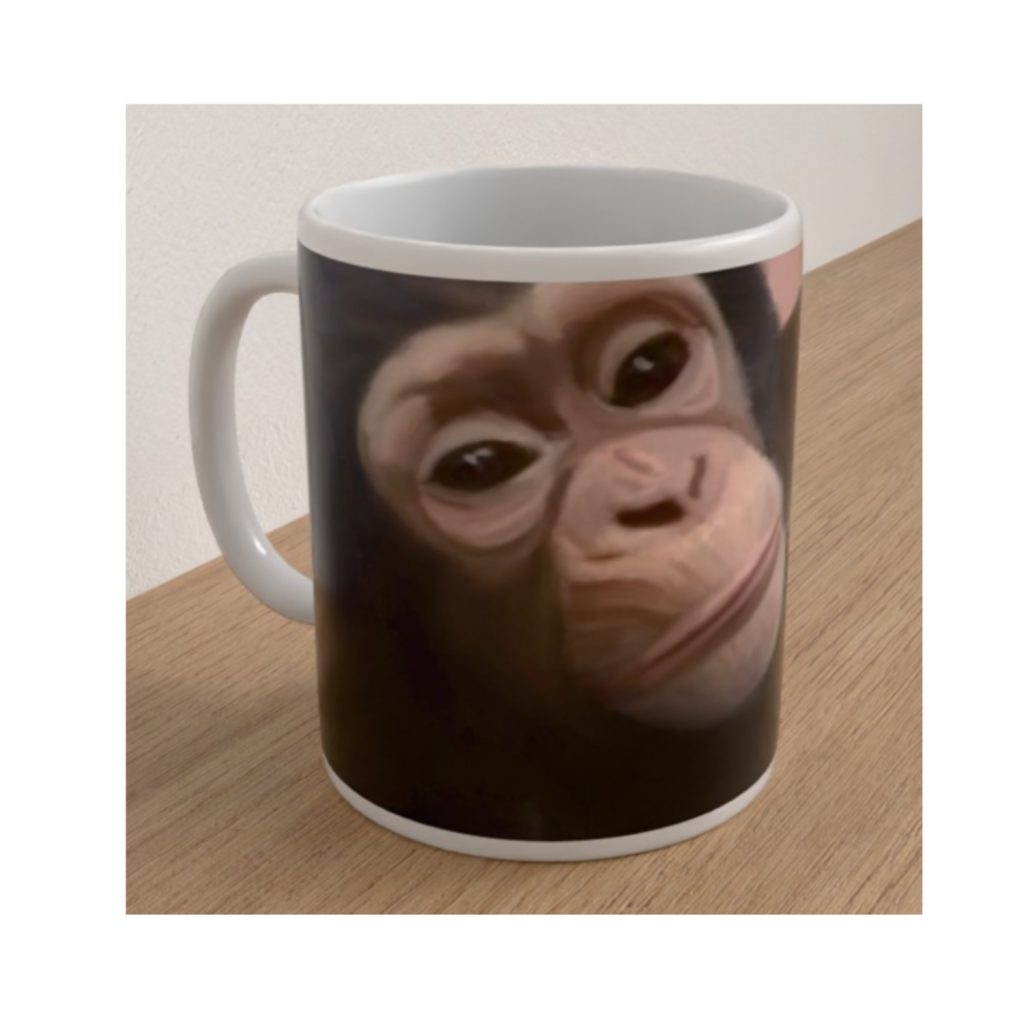 White ceramic Endangered Chimpanzee mug featuring a detailed illustration of a young chimpanzee's face against a dark background.