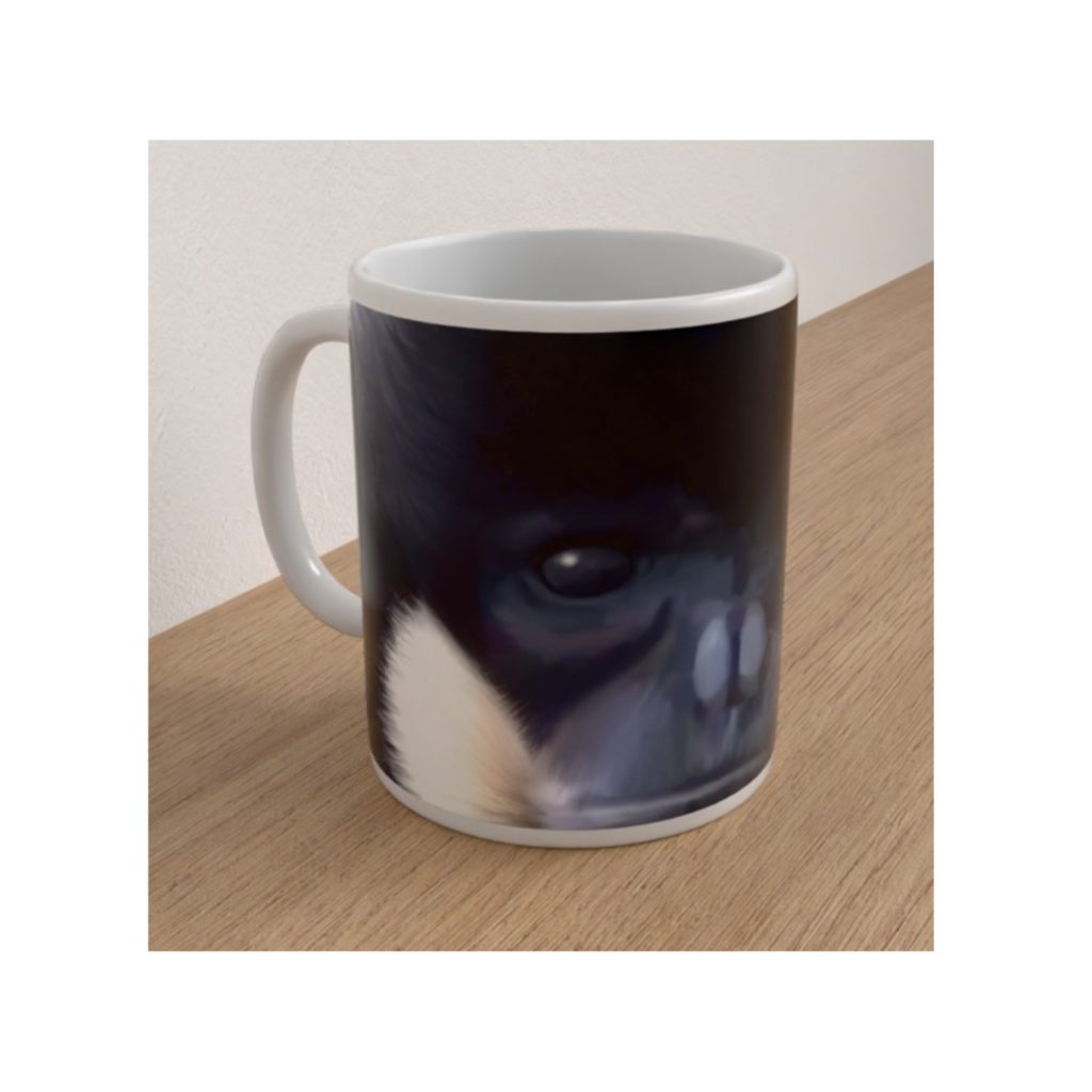Angled white ceramic mug featuring a close-up black-crested gibbon face with dark eyes and pale cheek fur.