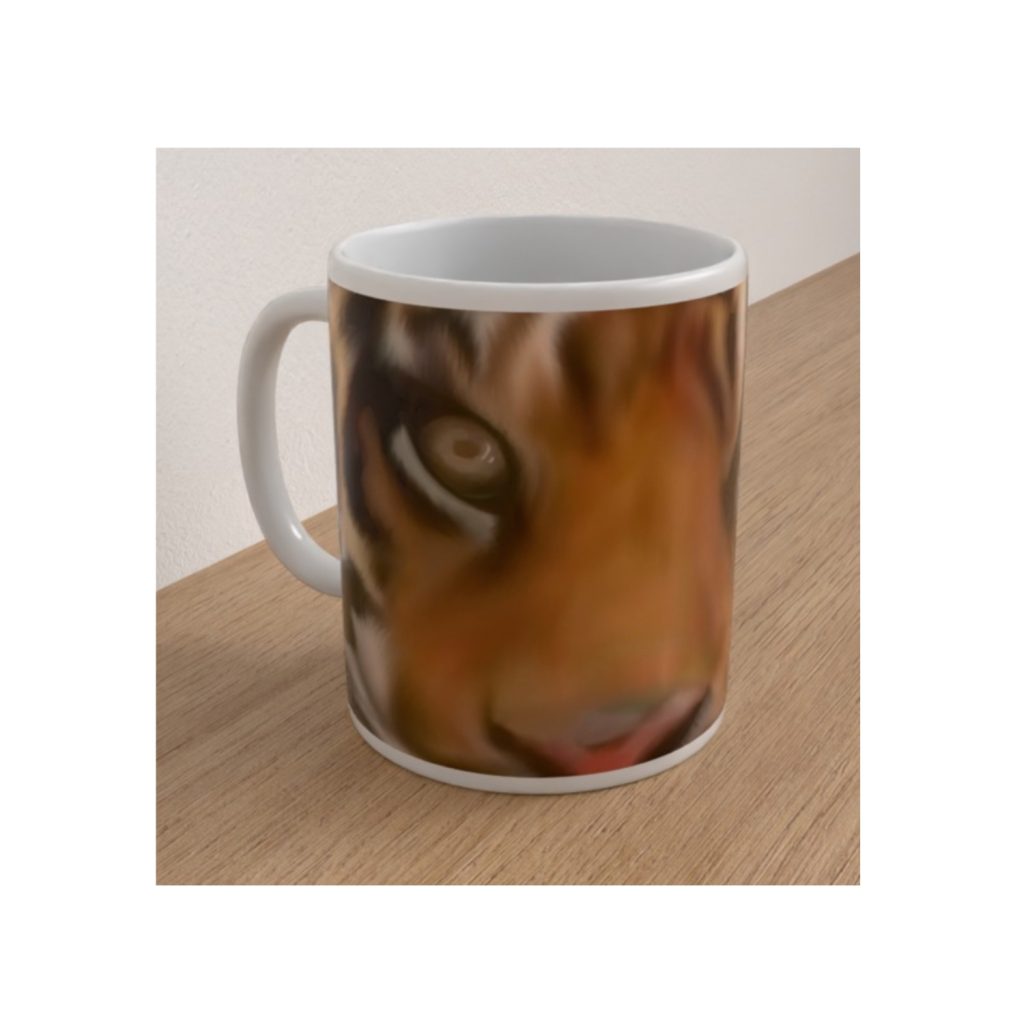 Angled white ceramic mug featuring a detailed close-up illustration of a tiger's face with one prominent eye.