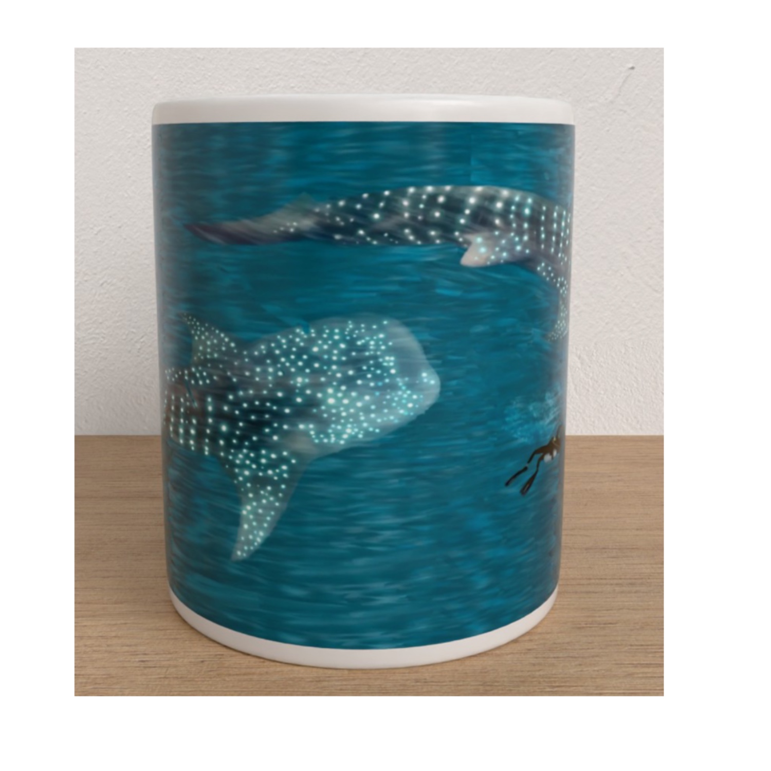 White ceramic mug featuring two spotted whale sharks swimming through deep blue ocean water.