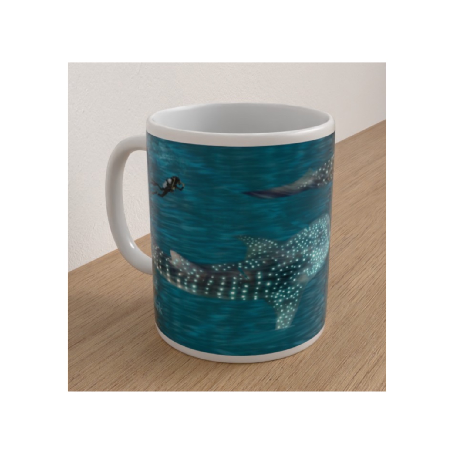 Angled white ceramic mug showing spotted whale sharks and a scuba diver swimming through blue ocean water.