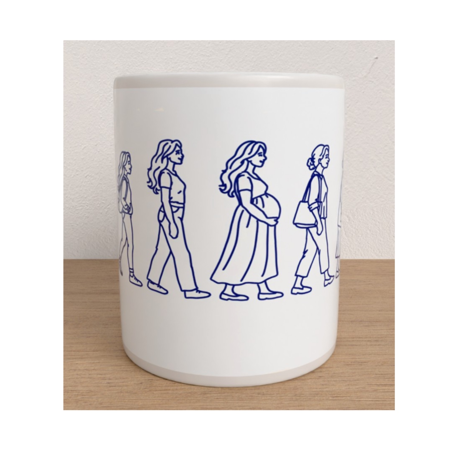 White Womanhood mug featuring blue line drawings of women walking, including a pregnant woman.