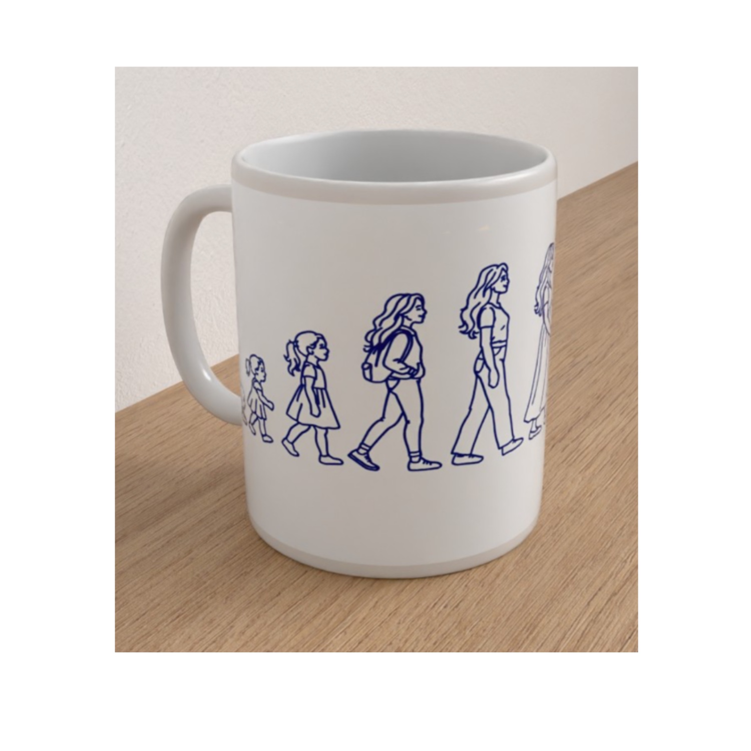White ceramic Womanhood mug featuring blue line drawings showing the stages of a woman's life from babyhood to adulthood.